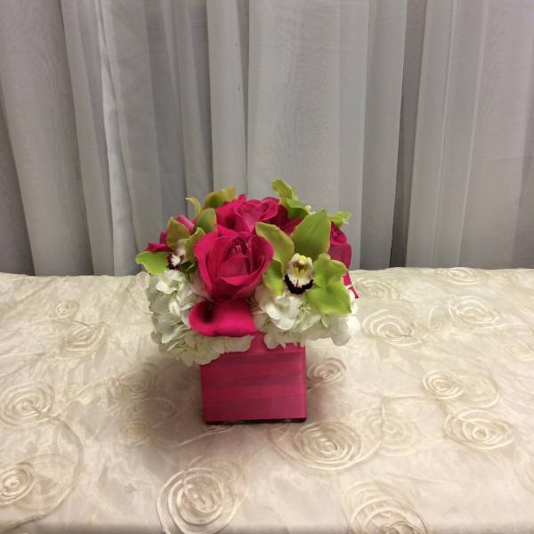 Pink rose and orchid arrangement in a square pink box