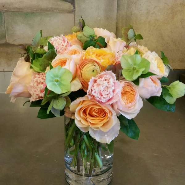 Peach and blush bouquet in a clear glass vase