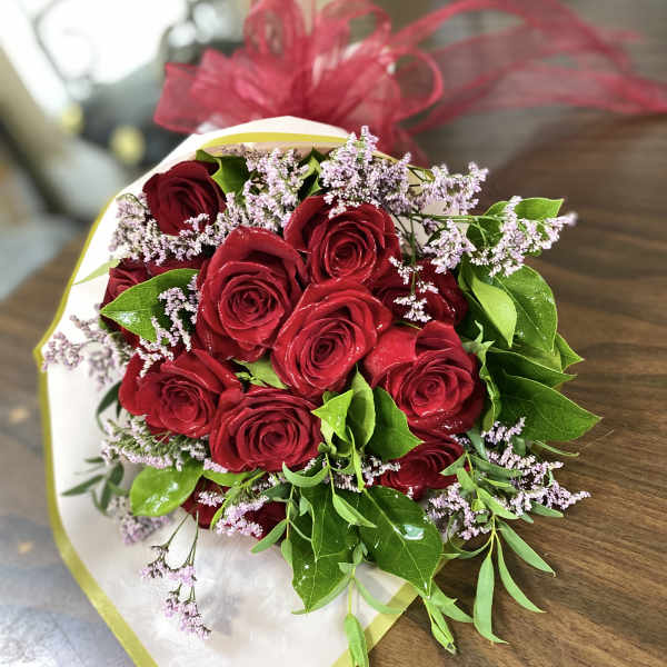 Bouquet of red roses with small lavender filler flowers