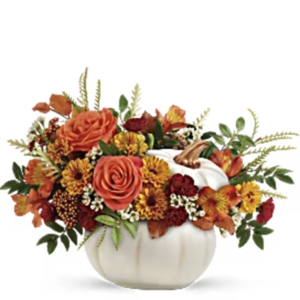 Orange and yellow floral arrangement in a white pumpkin-shaped container