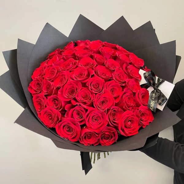 Large bouquet of red roses wrapped in black paper