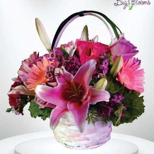 Pink and purple mixed flower basket with lilies and daisies