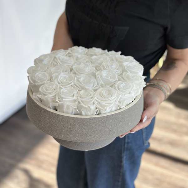 Round box filled with white roses