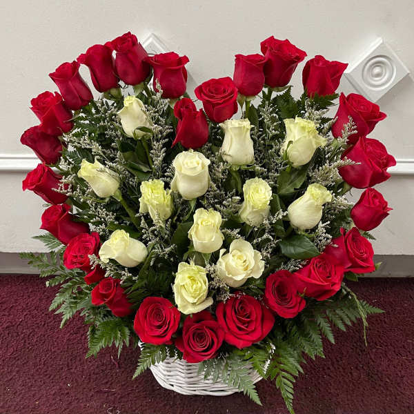Basket arrangement of red and white roses