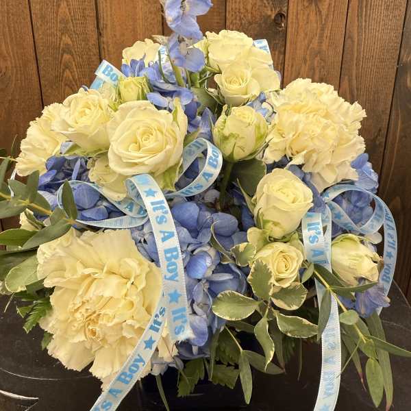 Blue and cream bouquet with roses, hydrangeas, and carnations