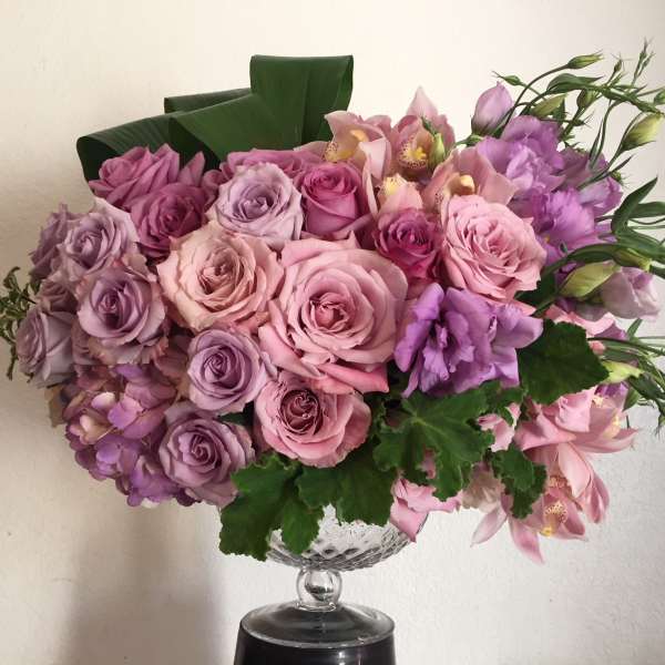 Pink and lavender rose bouquet in a clear glass vase