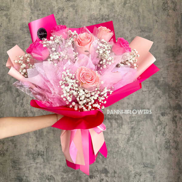 Pink rose bouquet with baby's breath and bright ribbon wrapping