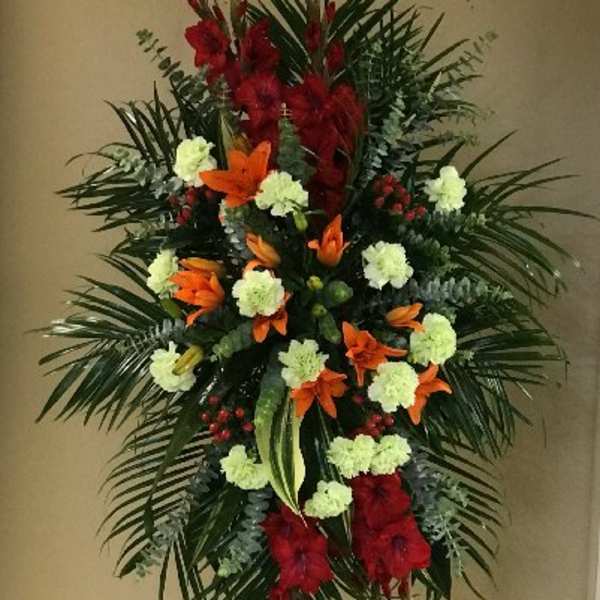 Tall standing floral spray with red, orange, and pale green flowers