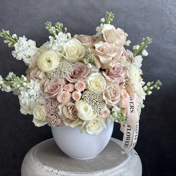 Blush and white rose bouquet in a white vase