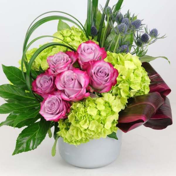 Pink roses and lime hydrangeas in a white vase