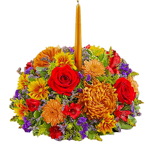 Colorful floral centerpiece with a tall gold candle in the middle