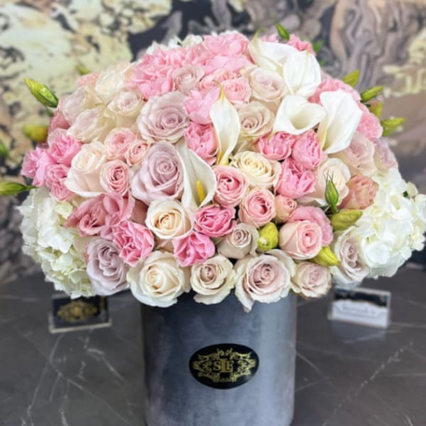 Pink and white rose bouquet in a gray hat box with white calla lilies