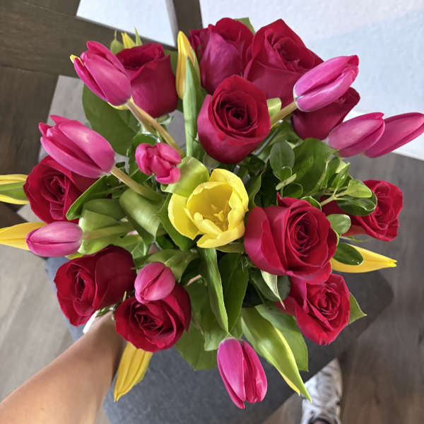 Bouquet of red roses with pink and yellow tulips