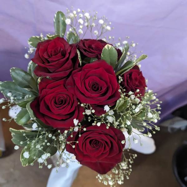 Bouquet of red roses with baby's breath and greenery