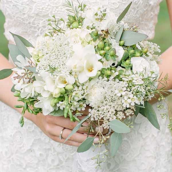 White bridal bouquet with eucalyptus and small white blooms
