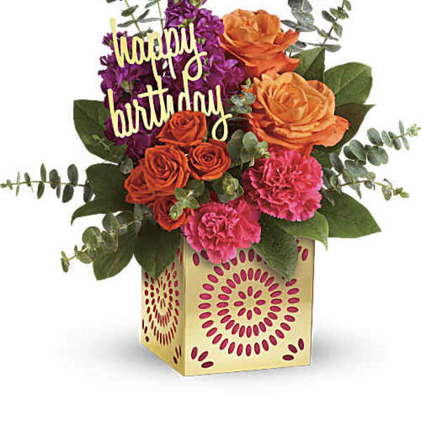 Birthday flower arrangement with roses, carnations, and a "happy birthday" sign in a gift box