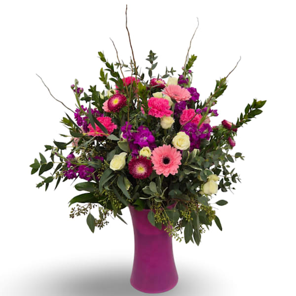 Pink and purple mixed bouquet in a magenta vase