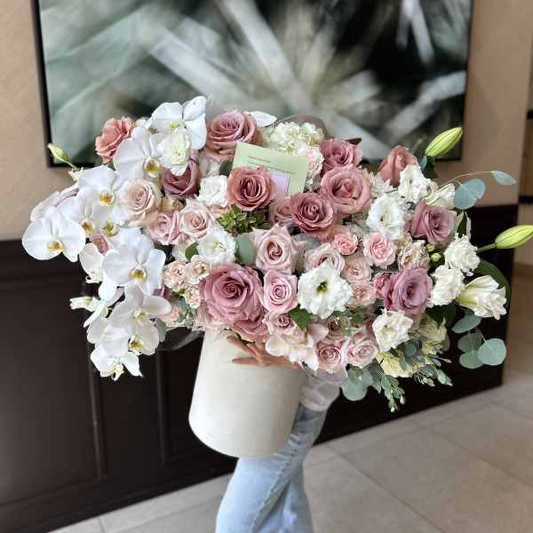 Large bouquet of pink roses and white orchids in a white box