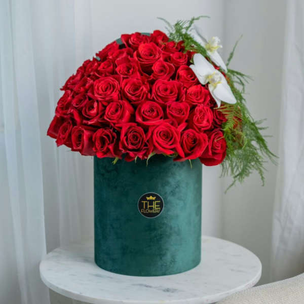 Large bouquet of red roses in a green velvet box with white orchids