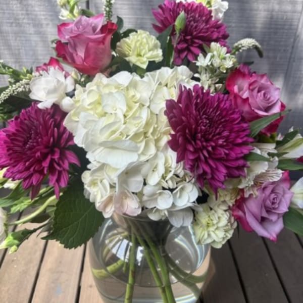 Pink and white mixed bouquet in a clear glass vase