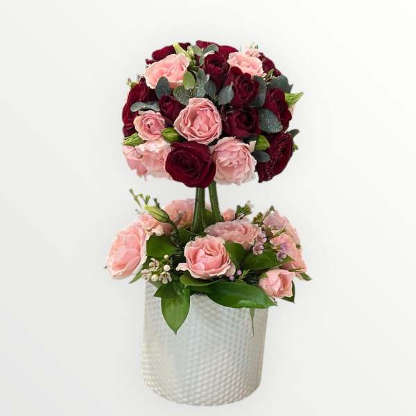 Two-tier rose arrangement in a textured white vase