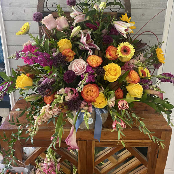 Large mixed bouquet with roses, lilies, and gerbera daisies in a vase