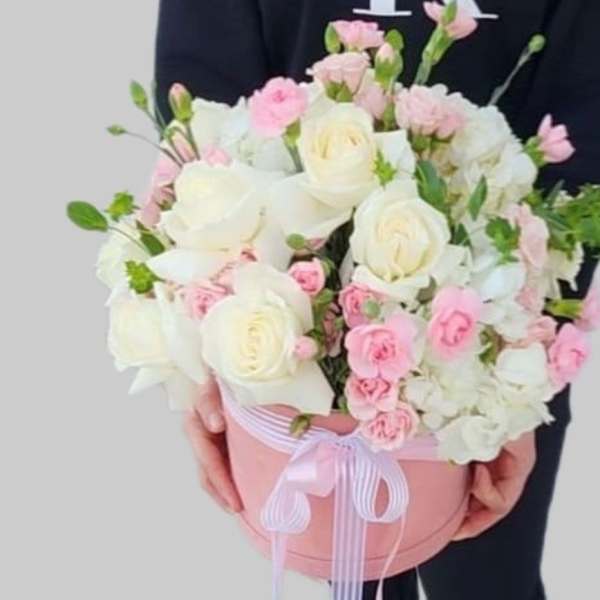 Pink and white bouquet in a round pink box with ribbon