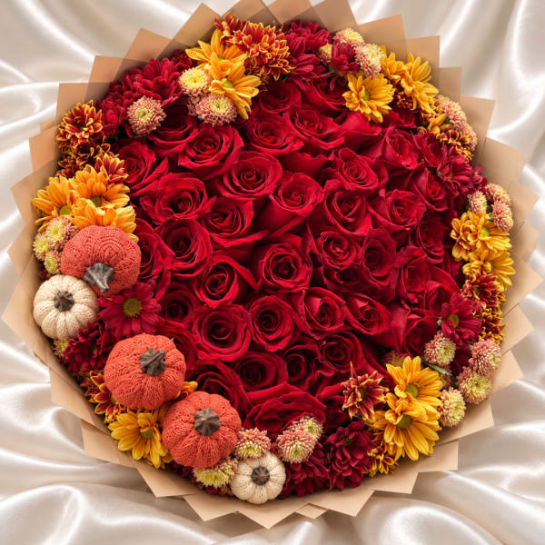 Bouquet of red roses with yellow and orange chrysanthemums and small decorative pumpkins