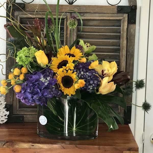 Colorful mixed flower arrangement in a clear glass vase