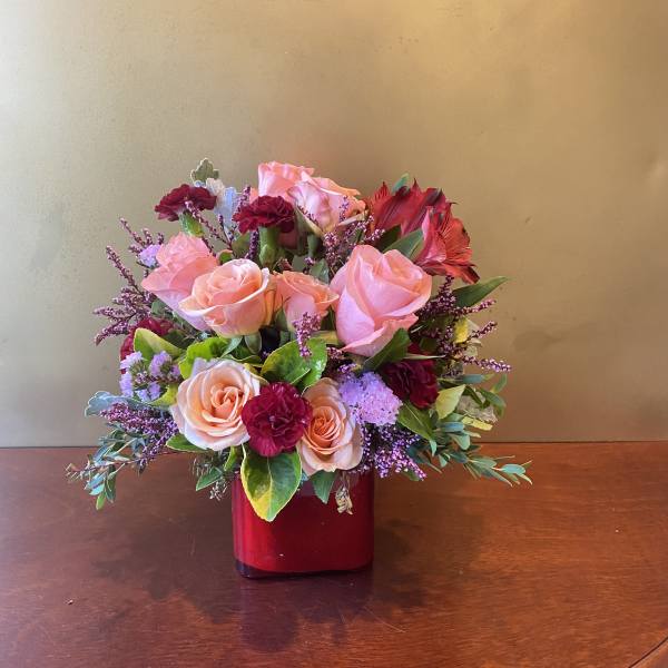 Pink and red rose bouquet in a red vase