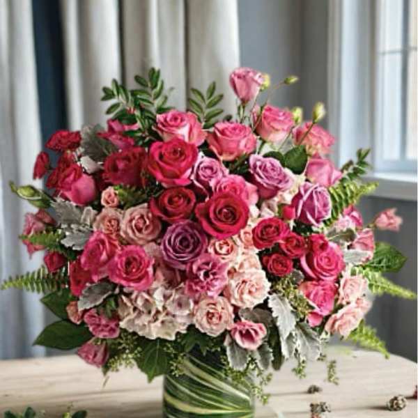 Pink and red rose arrangement in a glass vase
