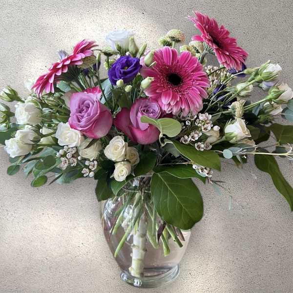 Pink and white mixed bouquet in a clear glass vase