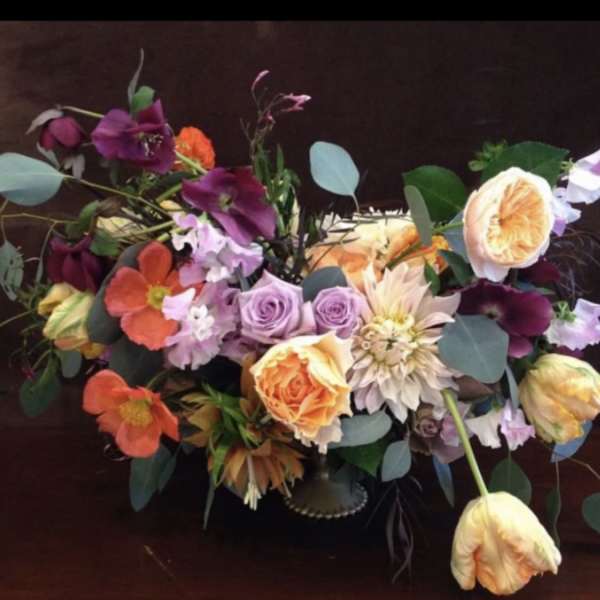 Colorful bouquet with roses, tulips, and mixed blooms in a low vase