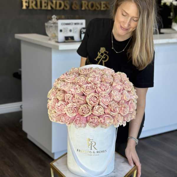 Large bouquet of pale pink roses in a white hatbox