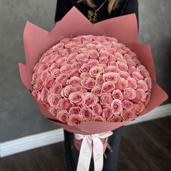 Large bouquet of pink roses wrapped in pink paper