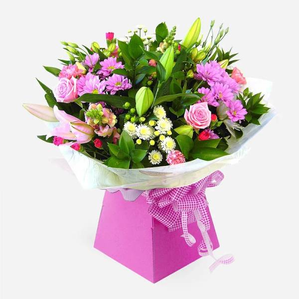 Mixed bouquet of pink and white flowers in a pink gift box