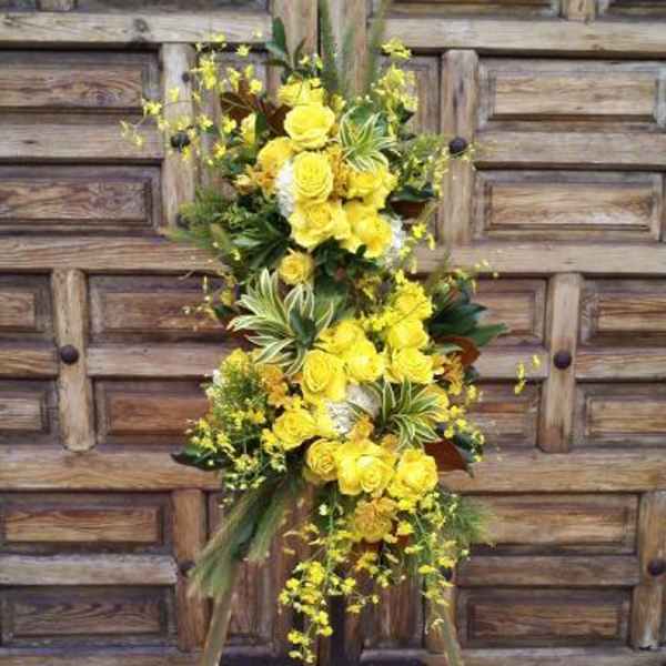 Tall yellow floral spray on a wooden easel