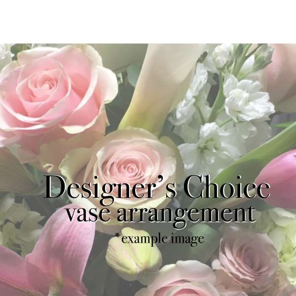 Pink roses and lilies with white flowers in a vase arrangement