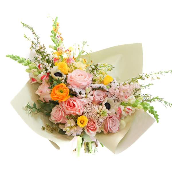 Bouquet of pink and orange flowers wrapped in pale paper