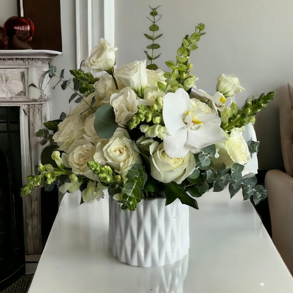 White floral arrangement in a textured white vase