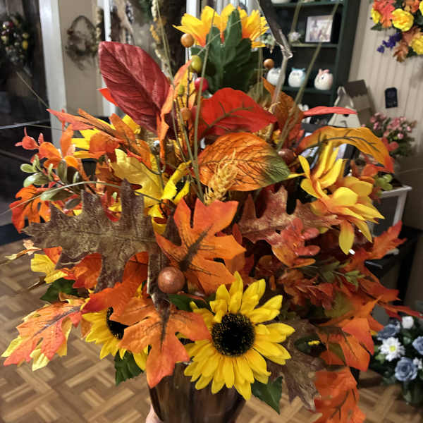 Autumn floral arrangement with sunflowers in a vase