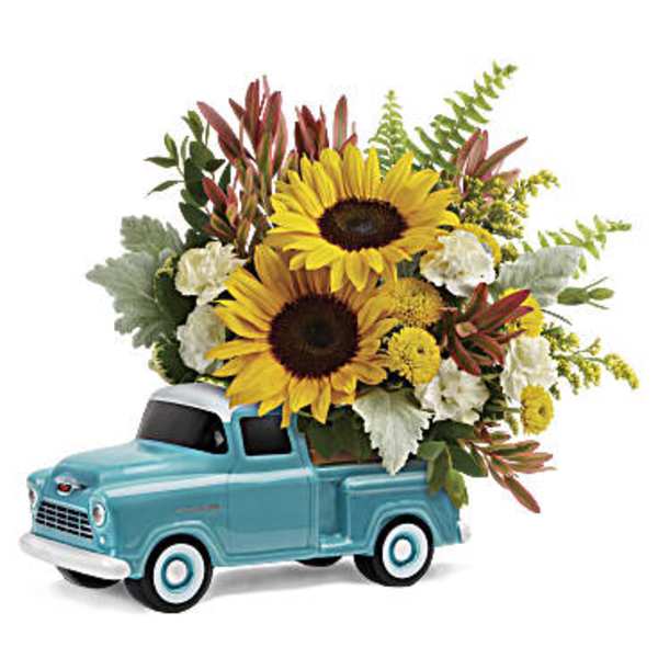 Sunflower arrangement in a blue toy pickup truck