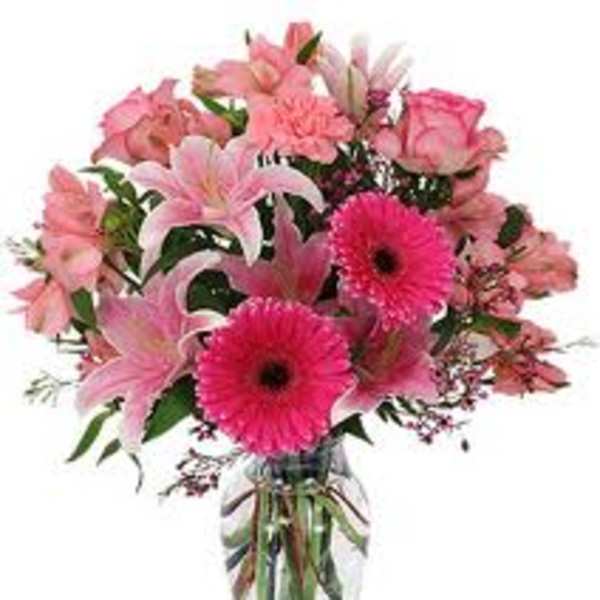 Pink mixed bouquet with lilies, roses, and gerbera daisies in a glass vase
