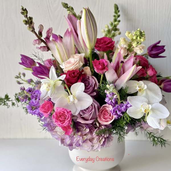 Pink and white floral arrangement in a white vase