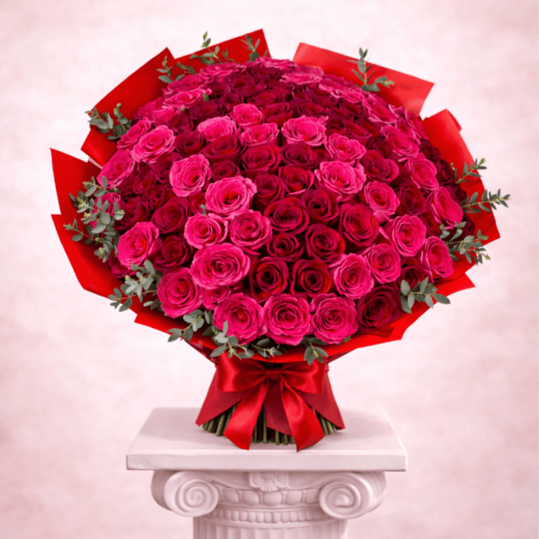 Large bouquet of pink and red roses wrapped in red paper
