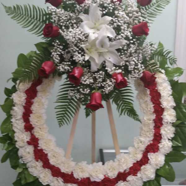 Standing floral wreath with red roses and white lilies