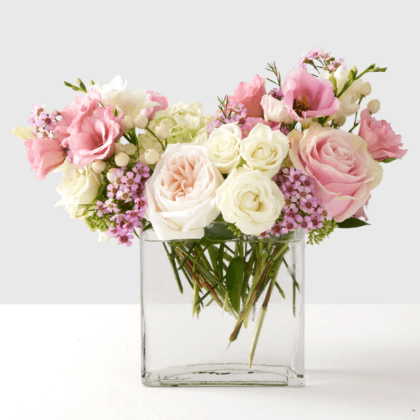 Pink and white roses in a clear glass vase