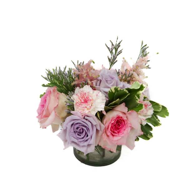 Bouquet of pink and lavender roses in a glass vase