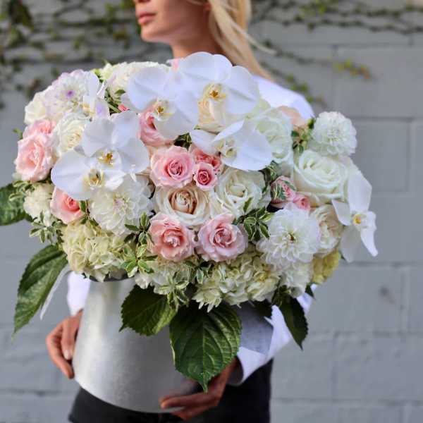 Large bouquet of white orchids, pink roses, and white hydrangeas