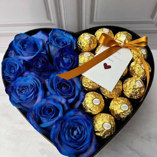 Heart-shaped box with blue roses and gold-wrapped chocolates